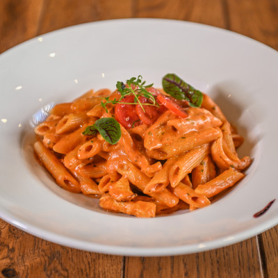 Penne with vegetables in red sauce